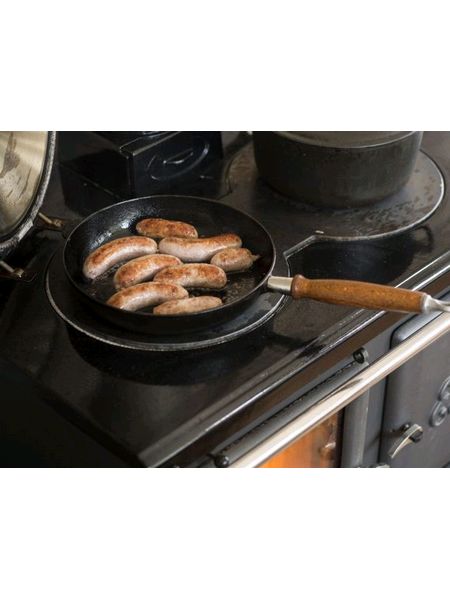 Esse Ironheart with sausages in a pan on hot plate