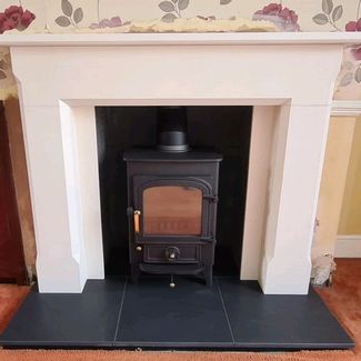 Clearview Pioneer 400 5Kw multi-fuel stove, honed granite boxed and lipped Hearth and Aegean limestone Mantel from Capital Fireplaces