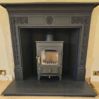 Clearview Pioneer 400 5Kw multi-fuel stove, honed granite Hearth and Stovax Cast Iron Mantel with reeded cast iron Panels installed in Walberswick