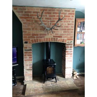 Here we hacked off the render to expose the original brickwork and laid a pamment tiled hearth