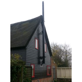 We installed this twin wall flue on the outside of this thatched barn conversion
