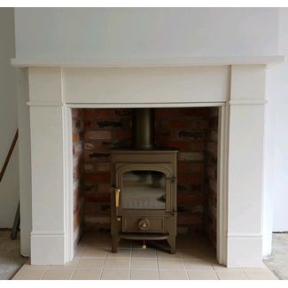 Clearview Pioneer 400 on 2 inch legs in honey glow brown with a Capital fireplaces Rainbow brick chamber set and Hersham mantel