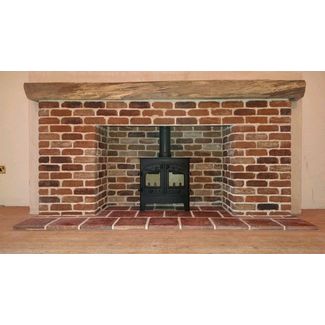 Extra large brick fireplace and timber beam shelf with red pamment tiled hearth. 