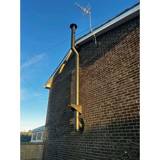 Black twin wall flue up the gable end of the house