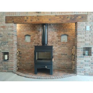 Burley Brampton 8kw woodburner on a log store in a brick fireplace