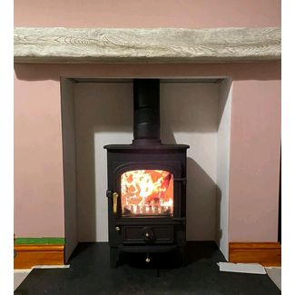 Clearview Pioneer 400 5kw multifuel stove with a Focus fireplace weathered character non combustible deep beam