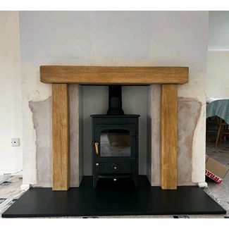 Clearview Pioneer 400 5kw stove with a riven slate hearth and a Barlby smooth finish non combustible surround