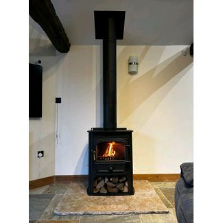 Clearview Solution 500 multifuel stove on a log store 8kw fitted to a black t w pro flue