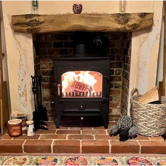 Clearview Vision 500 8kw multi fuel stove with a Vintage Honey Oak effect non combustible beam