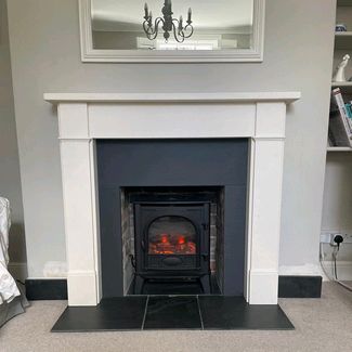 Gazco Stockton 5 electric stove with a Capital fireplaces Hersham mantel in Aegean limestone