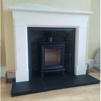Stovax Chesterfield 5 woodburner with a rusty slate chamber set and Aegean limestone mantel