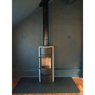 Tall modern woodburning stove clad with soapstone 
