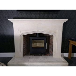Heta Inspire 45 in black 5kw output multi-fuel stove with a stone fireplace surround